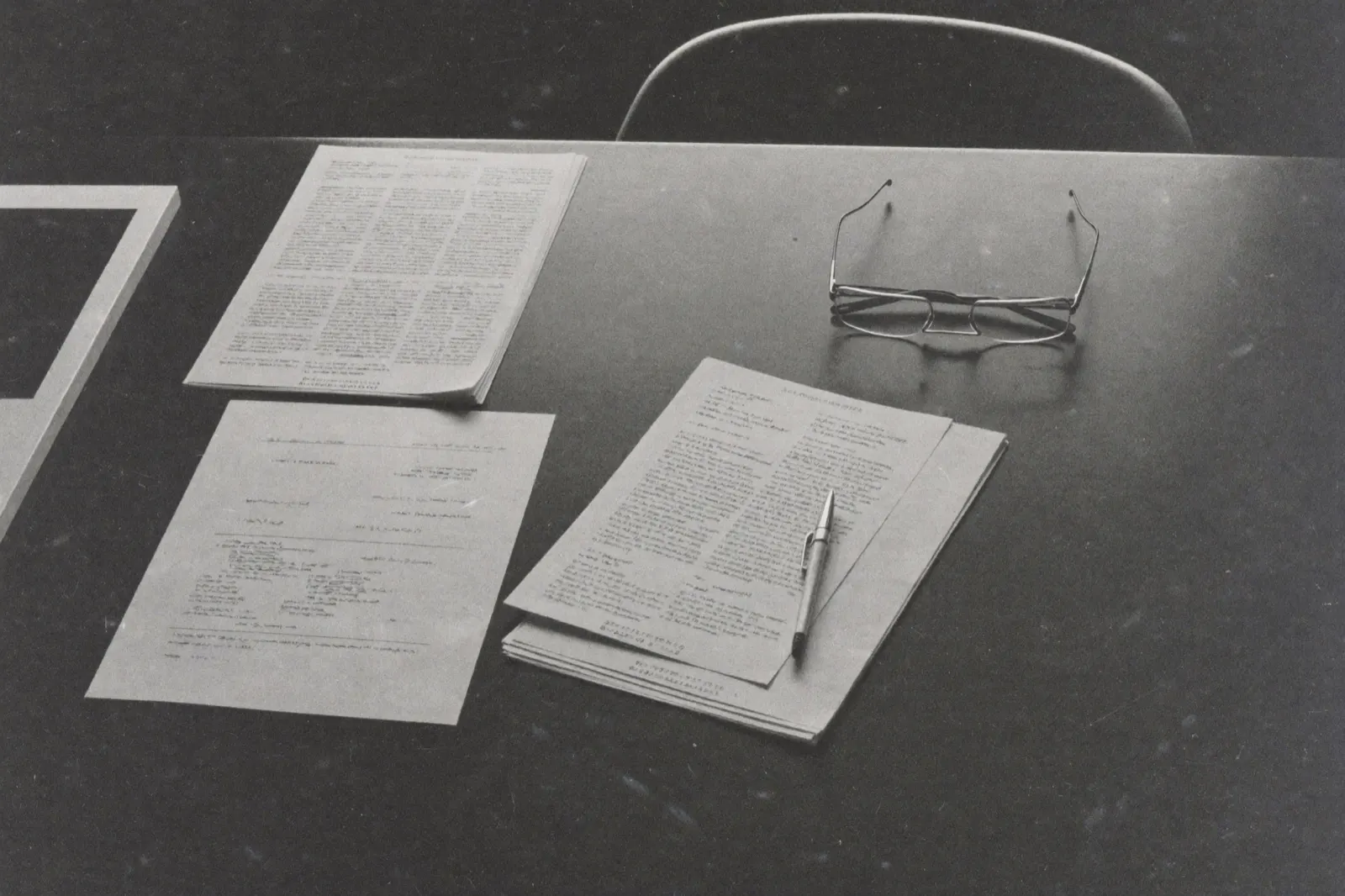 Annotated documents and charts on a desk